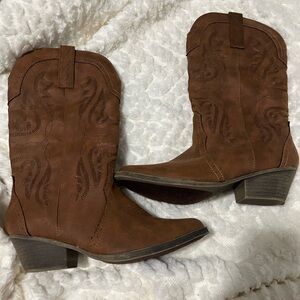 Brown cowgirl boot. Not sure of the brand